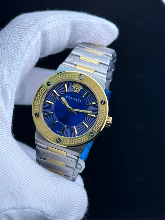 Versace Icon Greca tarzı kadın saat, mavi kadranlı, gold bezel ve çelik bilezikli pilli model