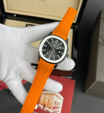 Patek Philippe Aquanaut, siyah grid desenli kadranlı, turuncu kauçuk kayışlı, çelik kasalı, otomatik mekanizmalı, ince kasalı lüks yazlık saat