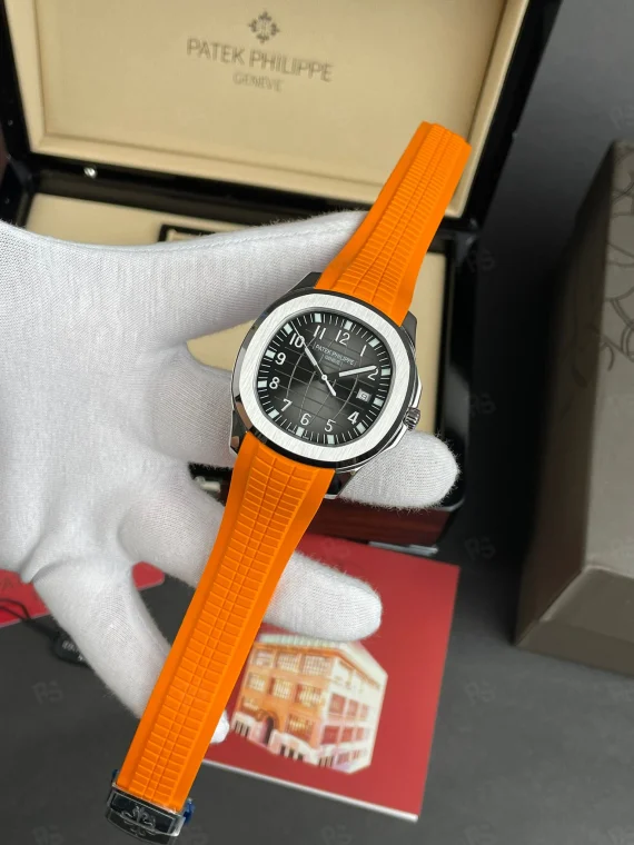 Patek Philippe Aquanaut, siyah grid desenli kadranlı, turuncu kauçuk kayışlı, çelik kasalı, otomatik mekanizmalı, ince kasalı lüks yazlık saat